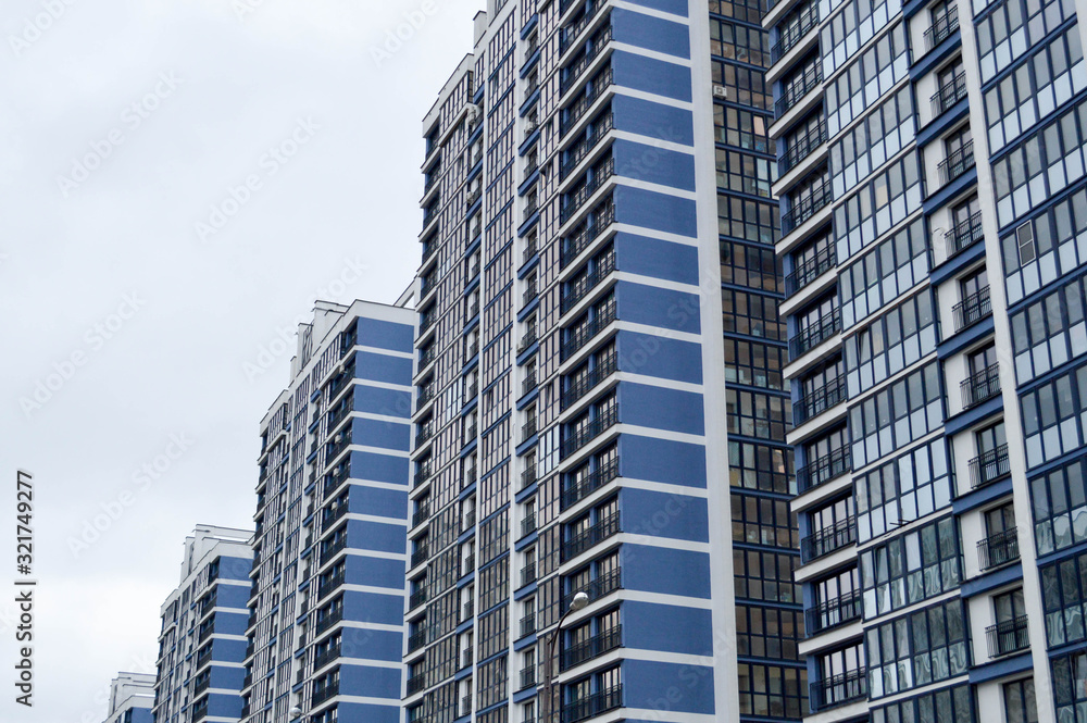 New modern tall blue glass multi-storey comfortable urban monolithic frame houses buildings skyscrapers new buildings in the big city of the megalopolis New modern tall blue glass multi-storey comfortable urban monolithic frame houses buildings skyscrapers new buildings in the big city of the megalopolis