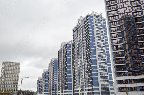 New modern tall blue glass multi-storey comfortable urban monolithic frame houses buildings skyscrapers new buildings in the big city of the megalopolis