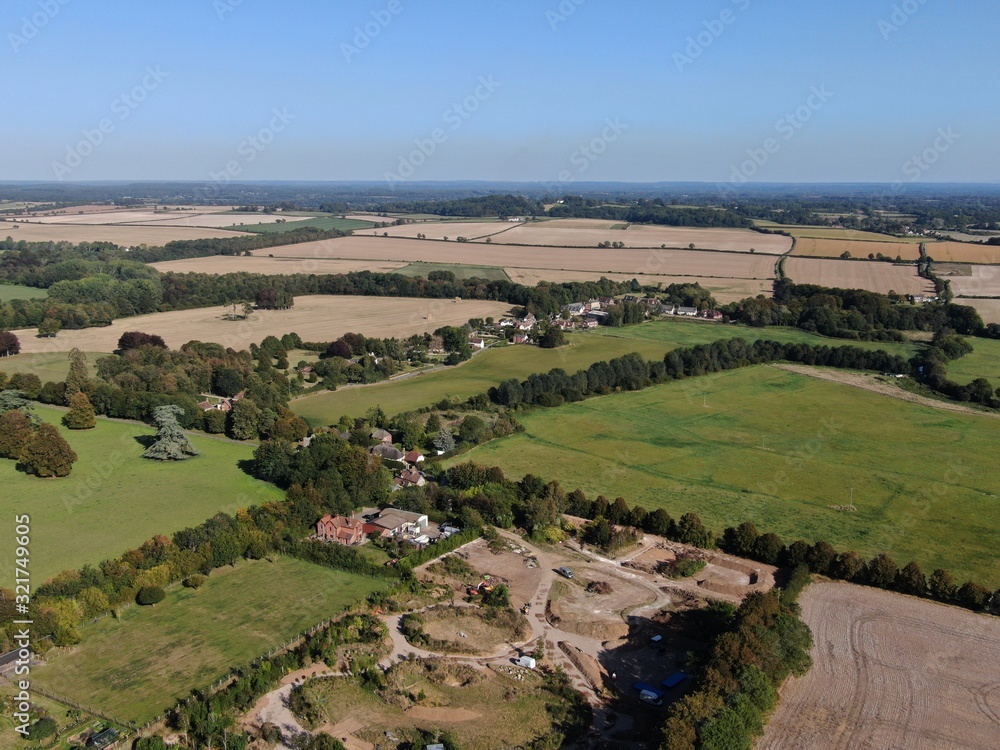 Naklejka premium aerial view of Dorset countryside with green and golden flat fields in the summer