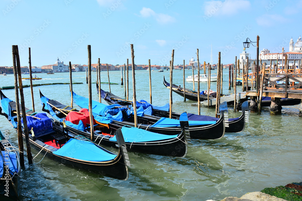 Venetian boats, gondolas, moored in harbor, near St Mark's Square, Venice, Italy