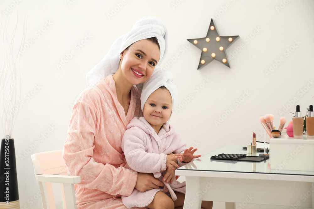 Young mother and little daughter at dressing table Young mother and little daughter at dressing table