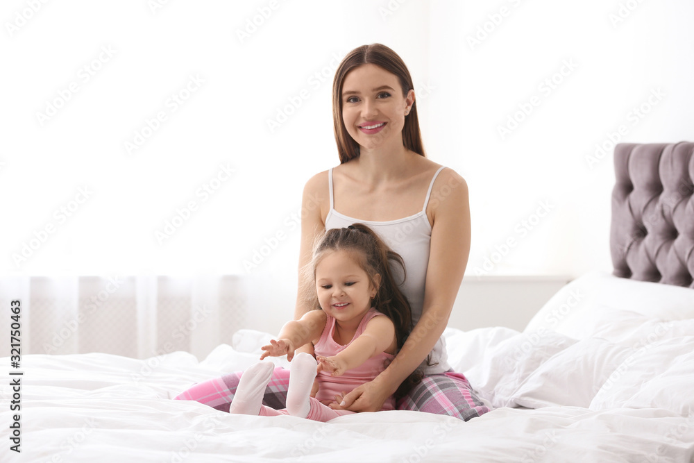 Happy mother with little daughter in bedroom Happy mother with little daughter in bedroom