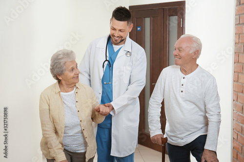 Doctor with senior patients at modern hospital