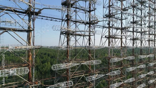 Aerial view of the DUGA radar station near the city of Chernobyl-2 among the forest. Exclusion Zone. Camera pans right. 4K drone footage. Close-up. photo