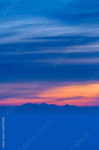 Dreamy blue and pink snowy landscape at sunrise or sunset