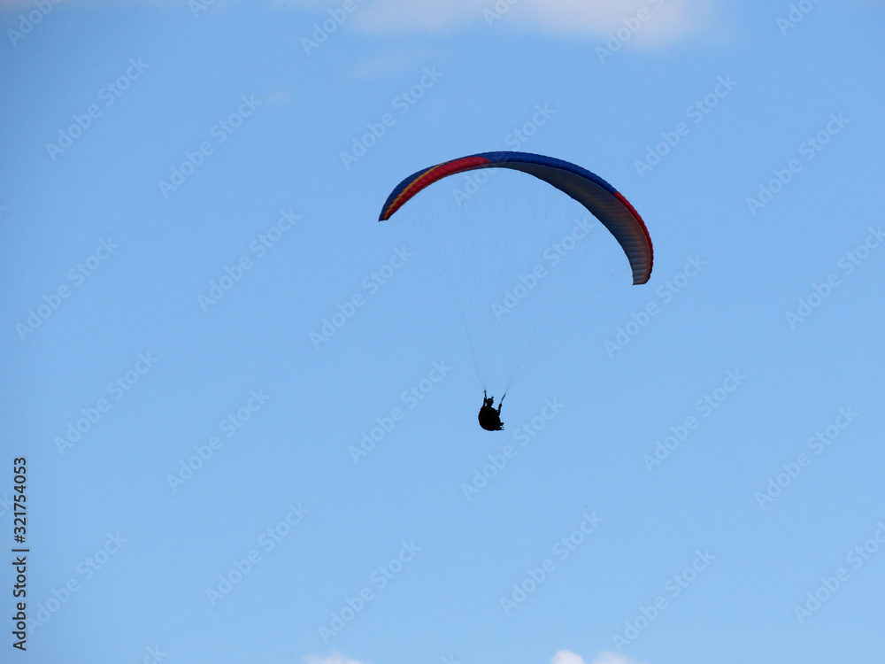 Paraglide flight in blue sky Paraglide flight in blue sky