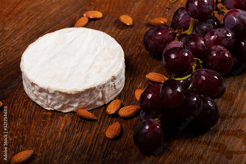Fototapeta premium Camembert cheese or brie on wooden background