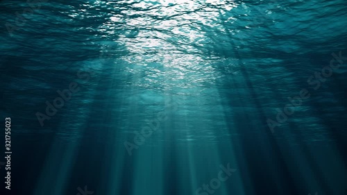 Underwater view with ocean waves flowing in the clear blue water. Beautiful aquatic view with sunbeams shining and creating god rays in the deep sea. 3D animation with swells and tidal waves photo