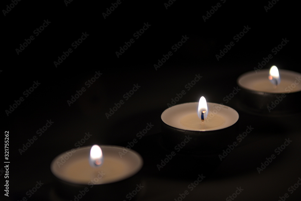 Small romantic candles against a dark background Small romantic candles against a dark background