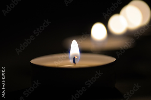 Small romantic candles against a dark background