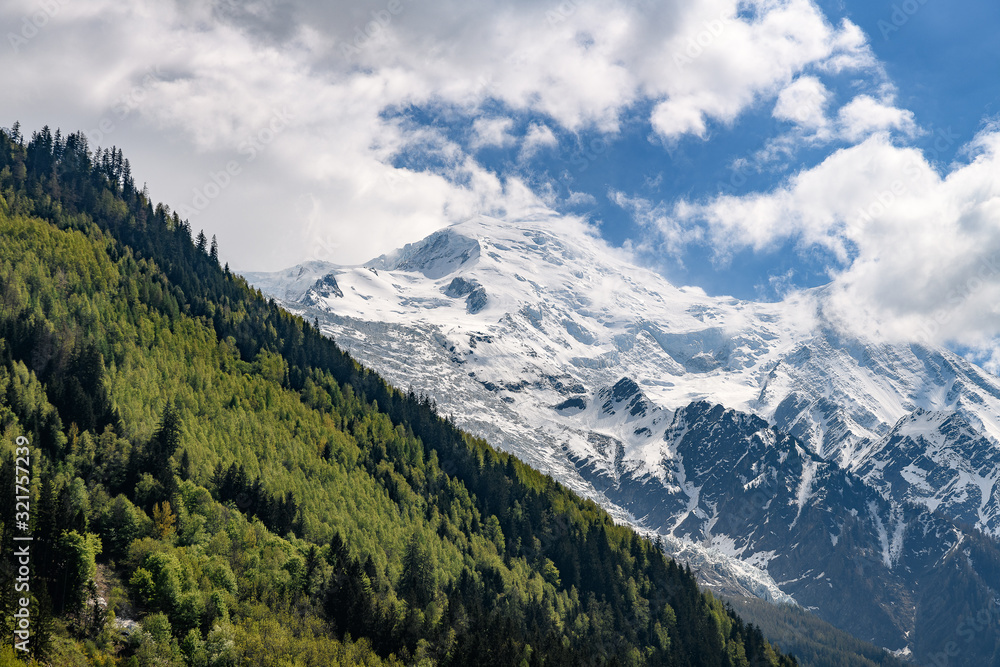 when spring meets winter. landscape of the french alps from Chamonix with green and snowy mountains