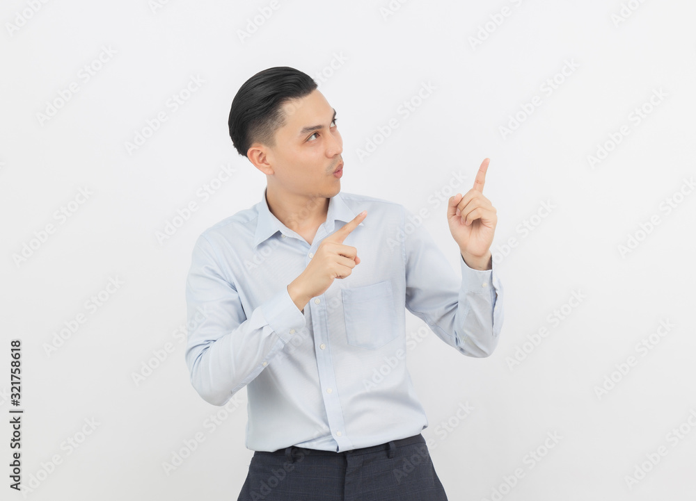 Young asian business man with blue shirt pointing to the side with a hand to present a product or an idea isolated on white background. Young asian business man with blue shirt pointing to the side with a hand to present a product or an idea isolated on white background.