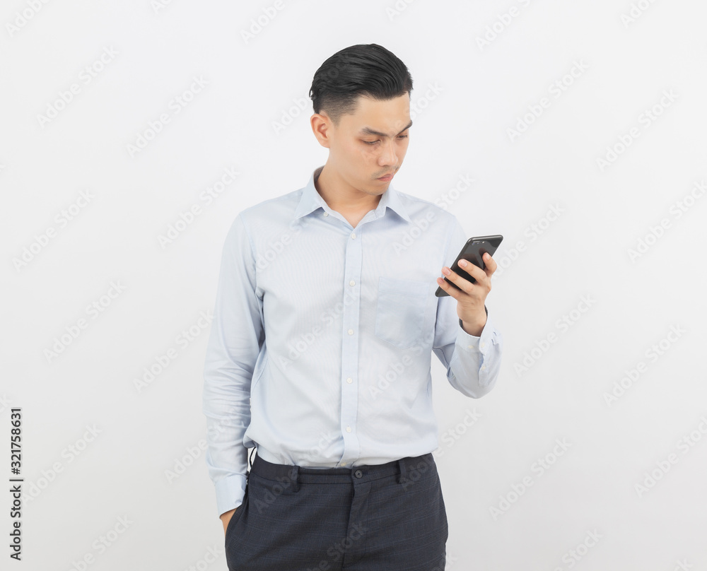 Young handsome asian business man playing smartphone and thinking isolated on white background. Young handsome asian business man playing smartphone and thinking isolated on white background.