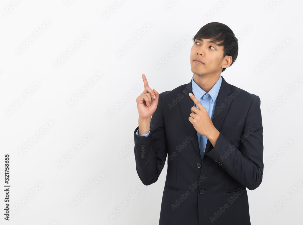 Young asian business man with blue shirt pointing to the side with a hand to present a product or an idea isolated on white background. Young asian business man with blue shirt pointing to the side with a hand to present a product or an idea isolated on white background.
