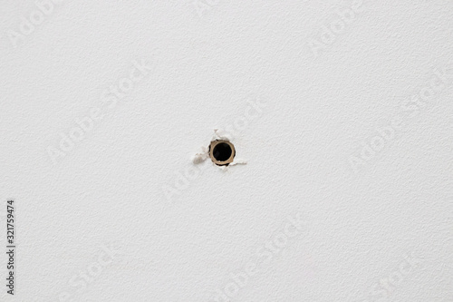 plastic dowel in a white drywall wall, straight view