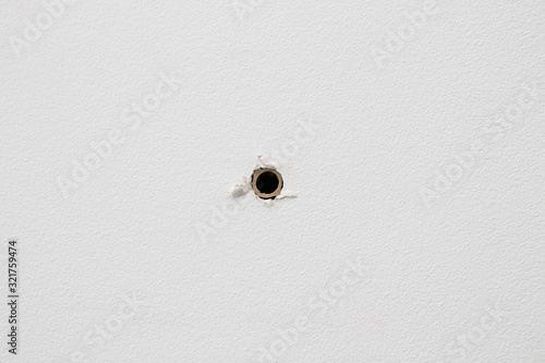 plastic dowel in a white drywall wall, straight view photo