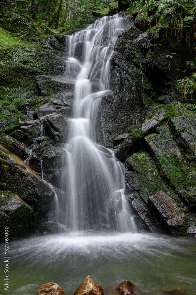 Waterfall with stones covered by moss in a forest (Uguisu's falls in Nara, Japan) Waterfall with stones covered by moss in a forest (Uguisu's falls in Nara, Japan)