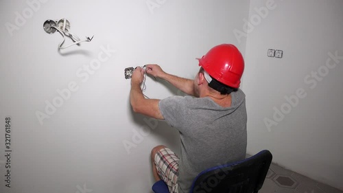 Careless electrician get electric shock. Man shake holding cable