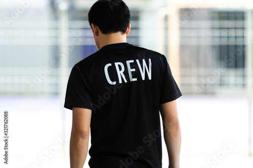Fotografering Back view of a young man wearing black CREW shirt
