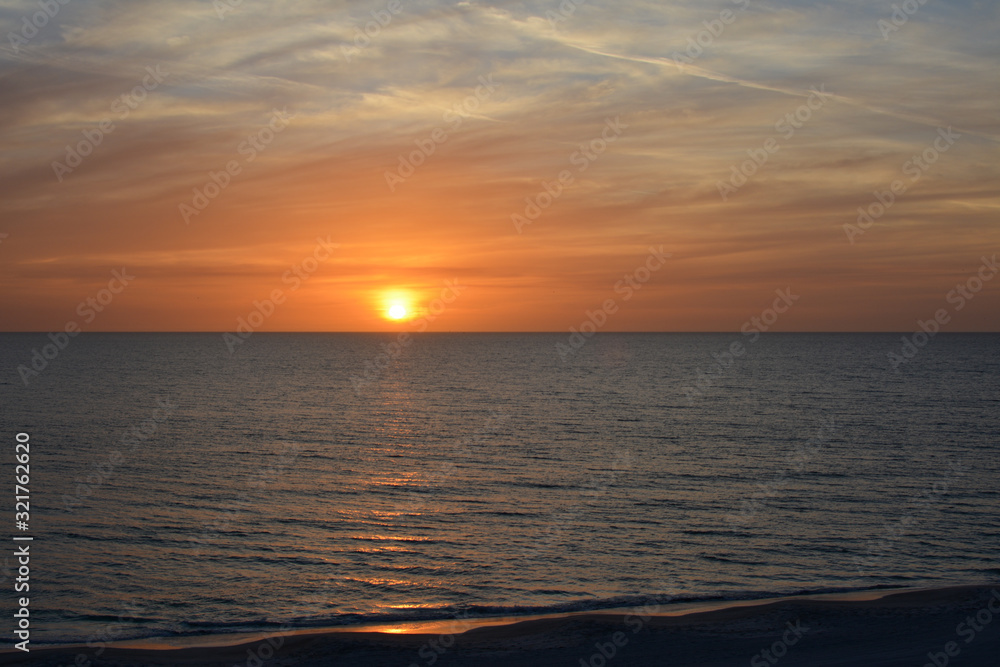 Sunset over the tropical calm waters of the Gulf of Mexico along the Florida coast Sunset over the tropical calm waters of the Gulf of Mexico along the Florida coast