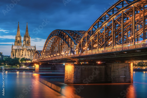 Cologne Cathedral and Hohenzollern Bridge during twilight photo