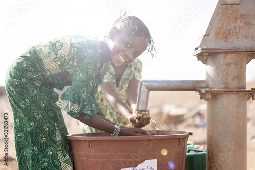 Slika na platnu Gorgeous Native Malian African girl so happy to finally get healthy fresh water