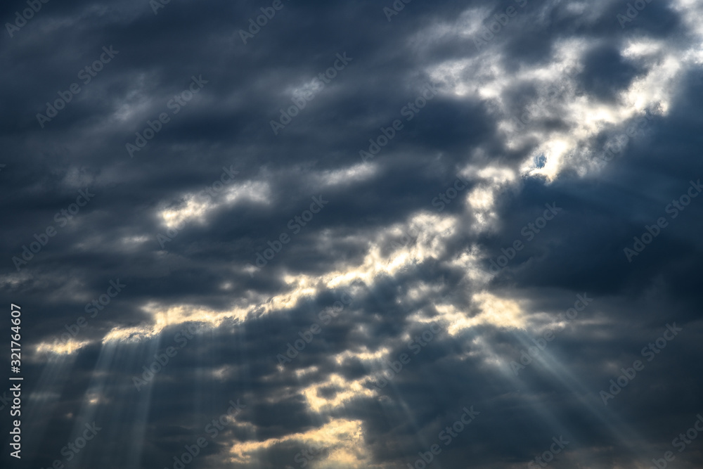sunlight beam through grey clouds