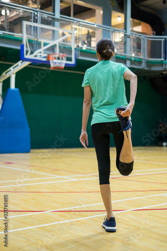 woman doing  stretching her legs in the sport club . The concept of a healthy lifestyle.. © byjeng