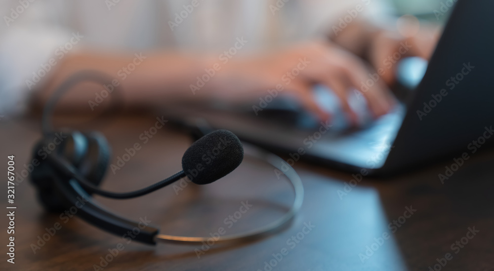 Businesswoman working on laptop and call center and customer service help desk. Businesswoman working on laptop and call center and customer service help desk.