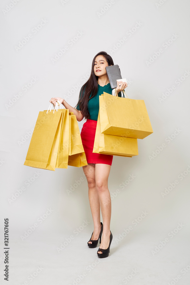 Smiling Young Woman Holding Shopping Bags Smiling Young Woman Holding Shopping Bags