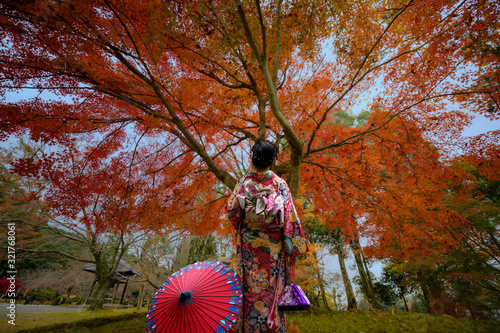 Photography woman holding retro umbrella in old fashion style, wearing traditional or origin