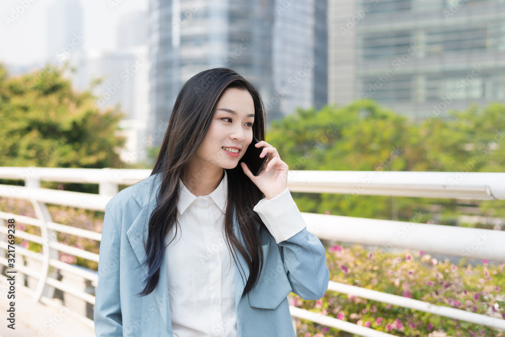 Young business women call in the business district Young business women call in the business district