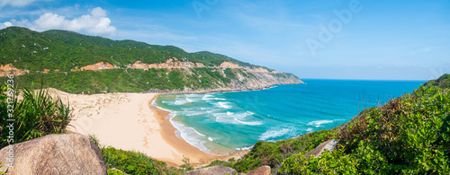 Expansive view of scenic tropical bay, Bai Mon gorgeous golden beach sand dunes blue waving sea. The easternmost coast in Vietnam, Phu Yen province between Da Nang and Nha Trang. photo