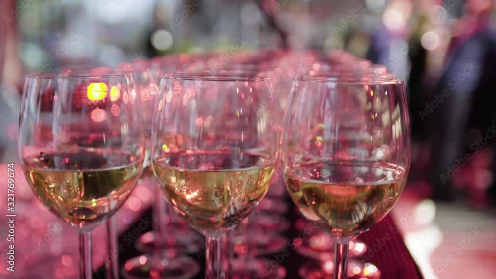 Glasses of wine set in rows during modern and classy event or wedding in 4K Glasses of wine set in rows during modern and classy event or wedding in 4K
