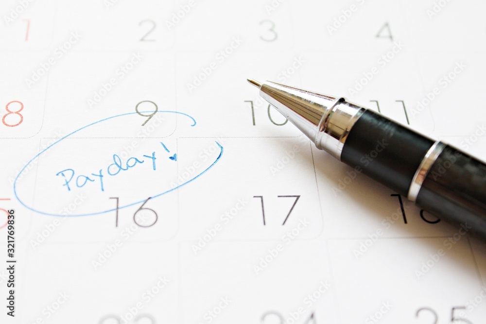 Fototapeta premium Business, finance, savings money, wages, payroll or accounting concept : Calendar with blue marker circle in word payday for remind