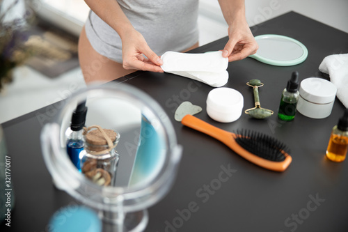Young woman holding disposable soft daily pad