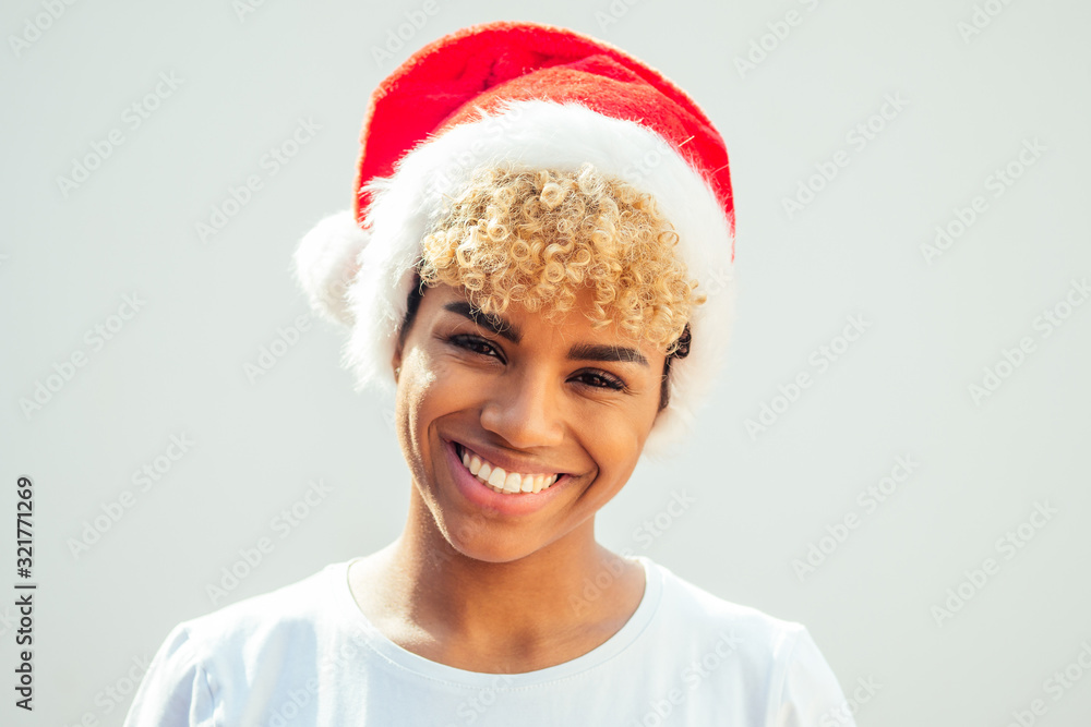african american girl with snow-white smile and curly blonde hair wearing red hat , looking at camera in studio white background african american girl with snow-white smile and curly blonde hair wearing red hat , looking at camera in studio white background