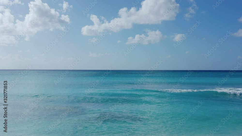 Gentle waves crashing on a beach in Grand Turk island in the Turks and Caicos archipelago. Static aerial shot Gentle waves crashing on a beach in Grand Turk island in the Turks and Caicos archipelago. Static aerial shot
