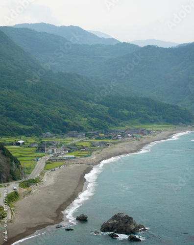 Small village on the coast surrounded by rice fields