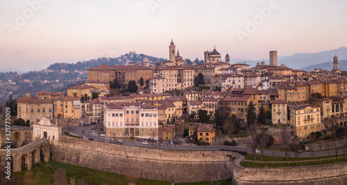 Bergamo, Italy. Drone aerial view of the old town during sunrise. Landscape at the city center, its historical buildings and the Venetian walls a Unesco world heritage