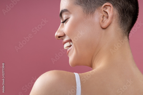 Delighted girl laughing with closed eyes stock photo