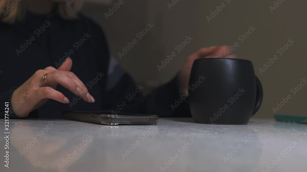 The girl works on the phone and drinks tea, 4K The girl works on the phone and drinks tea, 4K