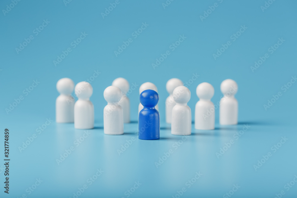 The leader in blue leads a group of white employees to victory, HR, Staff recruitment. The concept of leadership. The leader in blue leads a group of white employees to victory, HR, Staff recruitment. The concept of leadership.