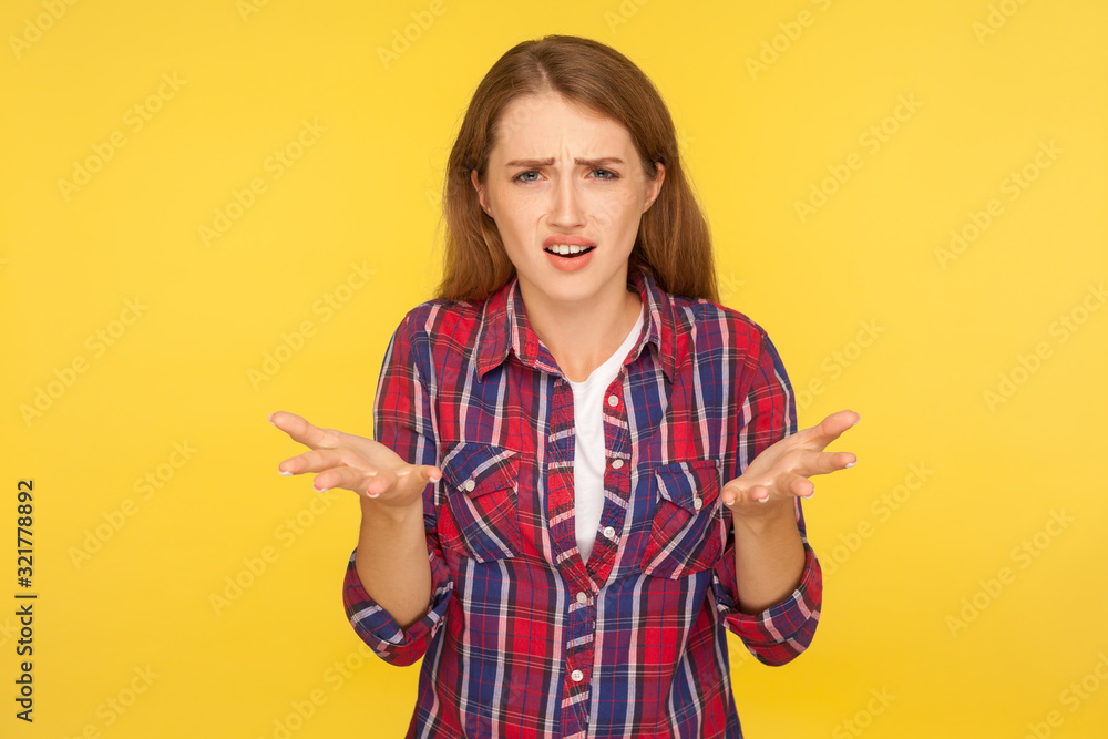 What do you want? Portrait of angry disgruntled ginger girl in casual shirt asking who why make this conflict, looking with annoyed indignant expression. studio shot isolated on yellow background What do you want? Portrait of angry disgruntled ginger girl in casual shirt asking who why make this conflict, looking with annoyed indignant expression. studio shot isolated on yellow background