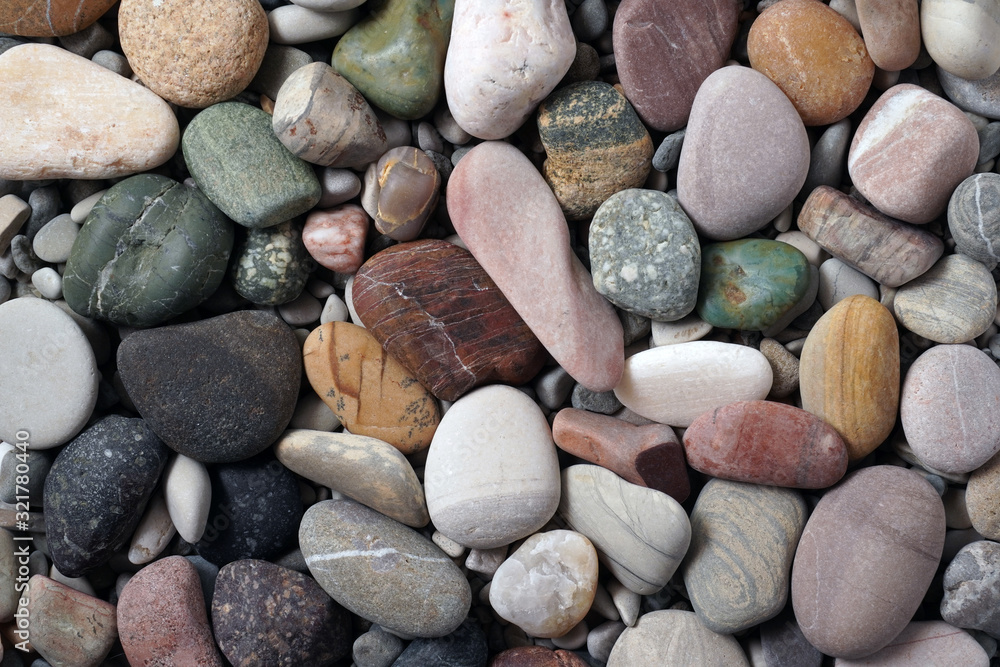 Gravel pattern of colored stones. Abstract nature pebbles background.Small sea stones on the beach, vacation at sea. Top view Gravel pattern of colored stones. Abstract nature pebbles background.Small sea stones on the beach, vacation at sea. Top view