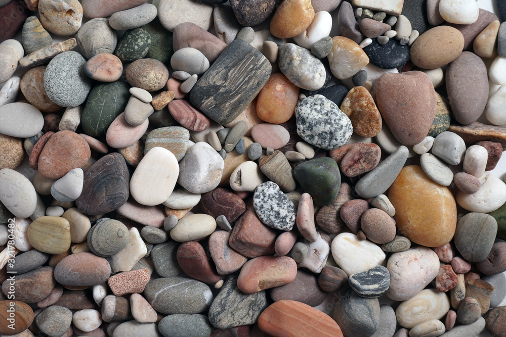 Gravel pattern of colored stones. Abstract nature pebbles background.Small sea stones on the beach, vacation at sea. Top view Gravel pattern of colored stones. Abstract nature pebbles background.Small sea stones on the beach, vacation at sea. Top view