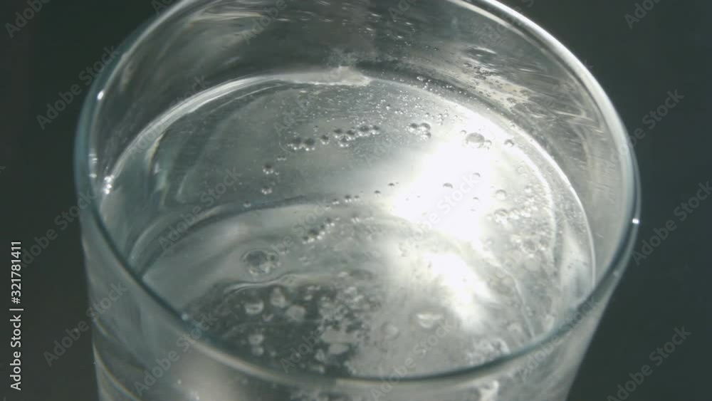 Dissolving fizzy tablet in a glass of water Dissolving fizzy tablet in a glass of water