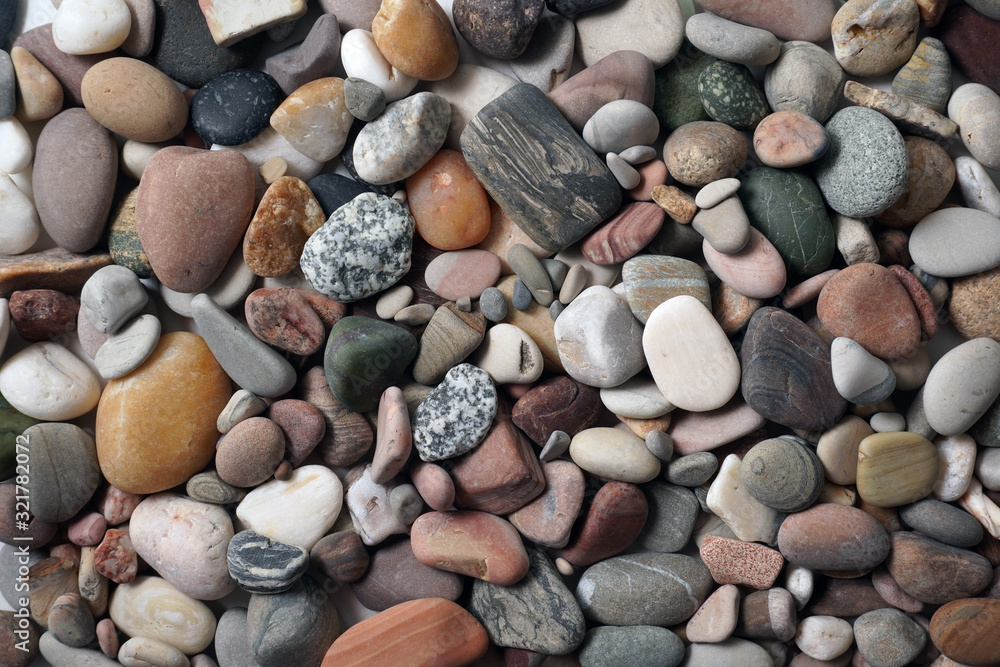 Gravel pattern of colored stones. Abstract nature pebbles background.Small sea stones on the beach, vacation at sea. Top view Gravel pattern of colored stones. Abstract nature pebbles background.Small sea stones on the beach, vacation at sea. Top view