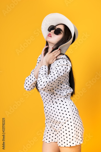 Asian woman in summer casual clothes.She smiling and  happy shopping. she  lovely attractive shine on  yellow background.Summer Surprise Sale  concept. © anon