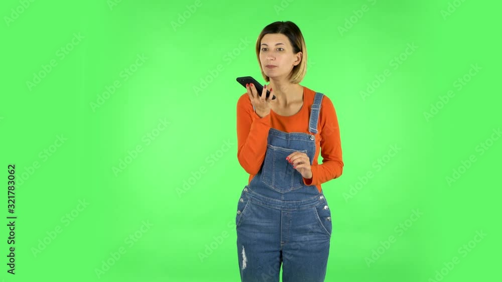 Girl asks for information on the network via phone on green screen Girl asks for information on the network via phone on green screen